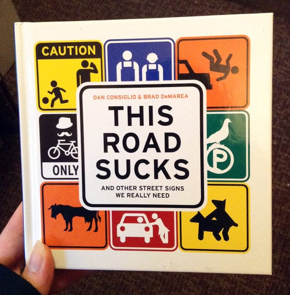 Running Press Books > Art & Gifts > Novelties This Road Sucks: And Other Street Signs We Really Need - Book 9780762454136 MC-20820